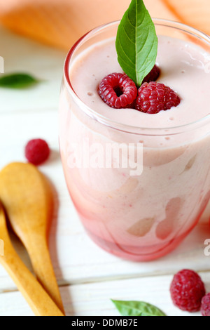 raspberry smoothie milk in a transparent glass, close up