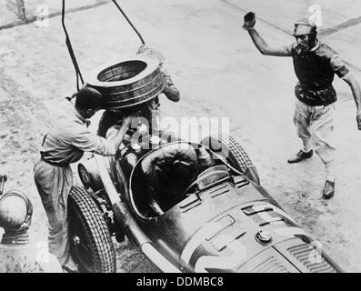 Tazio Nuvolari waiting for his car to be refuelled, c1930s(?). Artist: Unknown Stock Photo