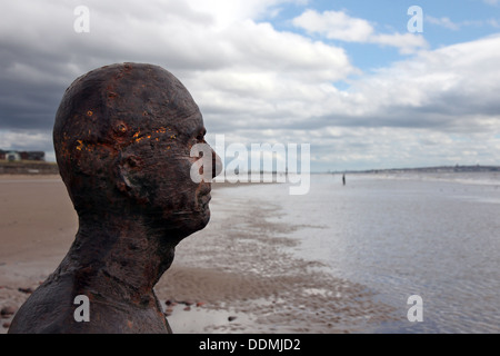 A statue on Crosby Beach stares out to sea. Stock Photo