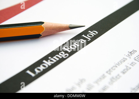 Looking for a job text on paper with pencil Stock Photo