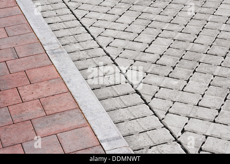Brick paving types with pink sidewalk, curb and drive made from plain interlocking concrete bricks Stock Photo