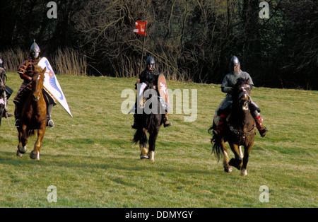 Medieval knight galloping on horseback holding the standard aloft in ...