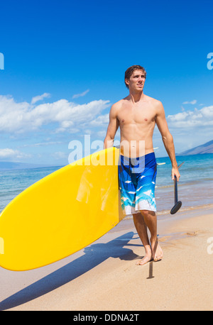 Man with Stand Up Paddle Board, SUP, on the beach in Hawaii Stock Photo