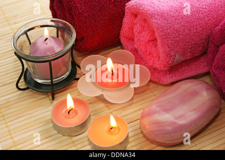 Towels, candles, soap on mat background. Stock Photo