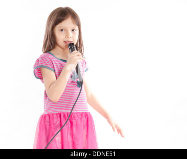 Asian female child singing with a microphone Stock Photo