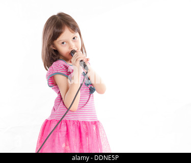 Asian female child singing with a microphone Stock Photo