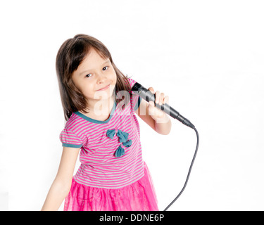 Asian female child singing with a microphone Stock Photo