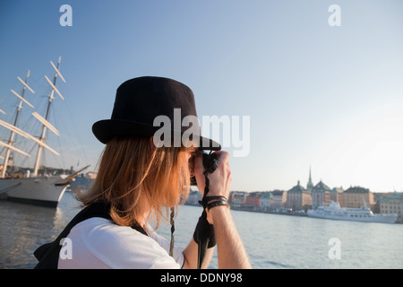 A photographer taking photographs of the waterfront in Stockholm, Sweden Stock Photo