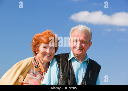 Happy senior couple together outside posing for a photograph Stock Photo