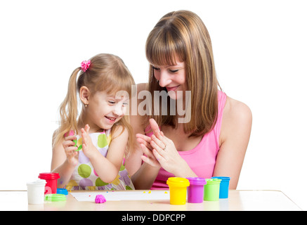 kid girl and mother playing colorful clay toy Stock Photo