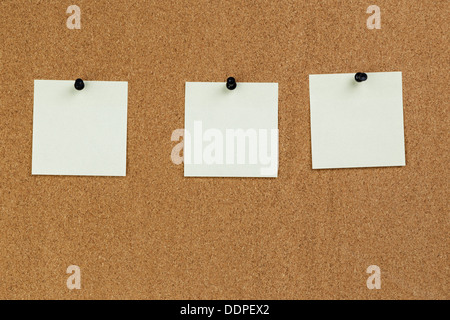 Blank colorful sticky notes or post-its on a cork board or