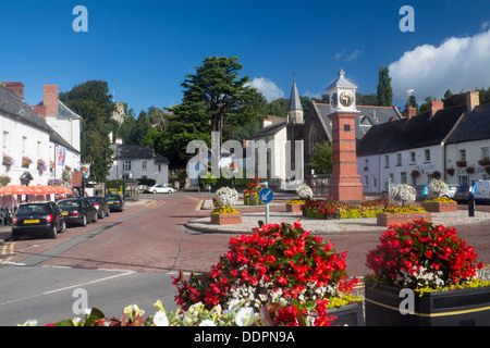 Usk Twyn Square in summer with flowers in bloom,clock tower, pubs on square and Castle Brynbuga Monmouthshire South Wales UK Stock Photo