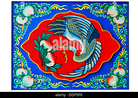 Oriental design of chinese crane bird painting and peaches on chinese temple wall in thailand Stock Photo