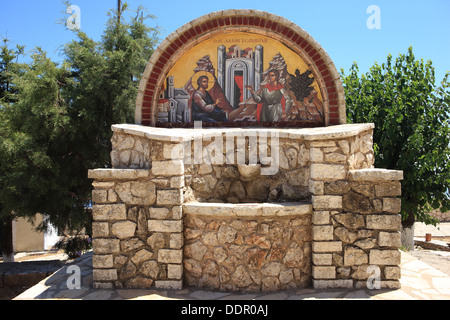 Religious decorated frieze over the well near the monastery on the top of Mount Pantokrator Stock Photo