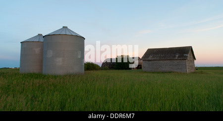 Silo and barn in a prairie field, Manitoba, Canada Stock Photo
