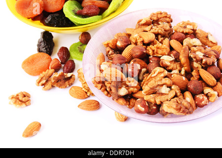 Dried fruits and nuts in vases isolated on white background. Stock Photo