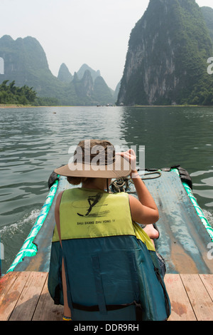 Tourist on a raft in Li River, Yangshuo, Guilin, Guangxi Province, China Stock Photo