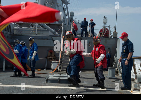 Sailors aboard the guided-missile destroyer USS Mahan (DDG 72) simulate firefighting on the flight deck during a crash and salv Stock Photo