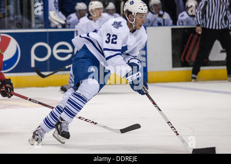 Toronto Maple Leafs' Morgan Rielly gets tangled up in the legs of ...