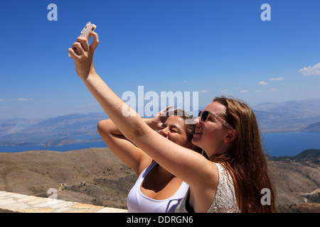 Girls on holiday taking a selfie, self-portrait photograph, the word made the Oxford Dictionaries online update in August 2013 Stock Photo