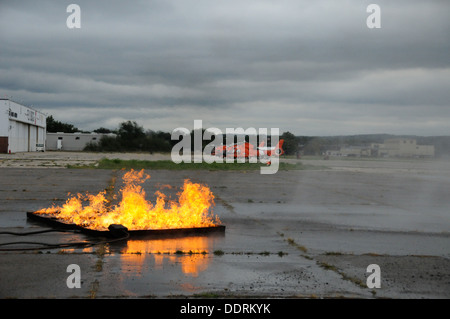 A fire burns on the tarmac at Coast Guard Air Station Traverse City, Mich,, during a firefighting exercise involving the Cherry Stock Photo