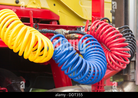 Air and electric connection lines, known as suzies, on an old articulated heavy goods vehicle (HGV) tractor unit in the UK. Stock Photo