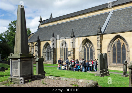 A group of tourists on a guided tour of Greyfriars Kirkyard, Edinburgh, Scotland, UK. Stock Photo