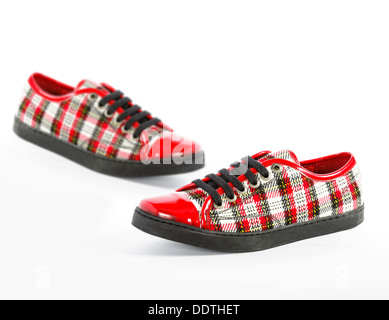 beautiful red women's shoes in a cage, plaid on a white background, isolated Stock Photo