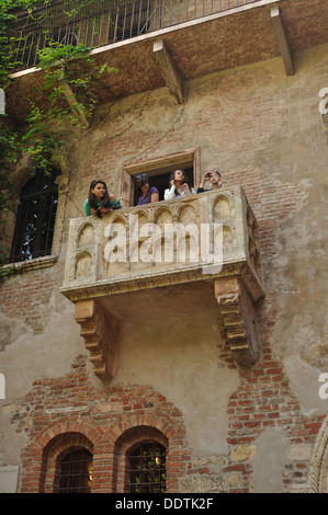 Four young would-be Juliets look out from her balcony in the Casa Di Giulietta, Verona. Stock Photo