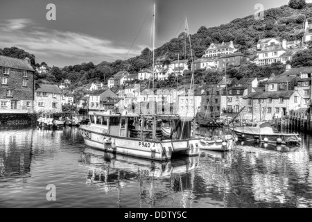 Boats in Polperro fishing village harbour Cornwall England in black and white HDR Stock Photo
