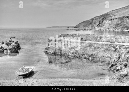 Boat in tiny Portwrinkle Cornwall harbour in black and white HDR Stock Photo