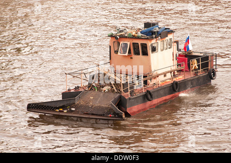 rubbish cleaner ship on the river Stock Photo