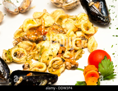 Tasty Orecchiette pasta with mussels, clams and vegetables. Stock Photo