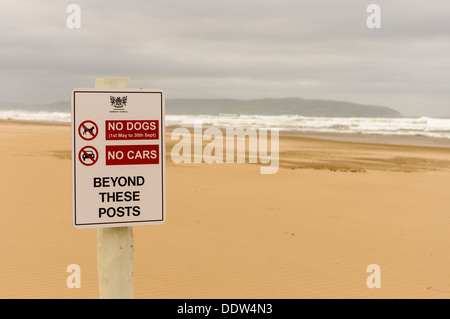 Sign on a beach warning that no dogs or cars are permitted beyond this point. Stock Photo