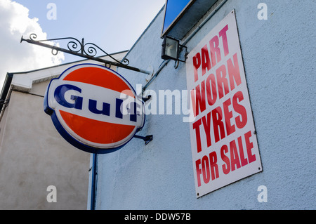 Sign at a garage advertising part worn tyres for sale beside a Gulf sign. Stock Photo