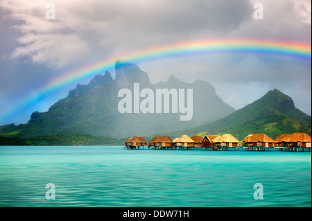 Bungalows over water with rainbow and Mt. Otemanu. Bora Bora. French Polynesia Stock Photo