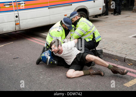London, UK. 07th Sep, 2013. An anti-Fascist protesters is arrested by police as Members of the far-right English Defence League march nearby. Credit:  Pete Maclaine/Alamy Live News Stock Photo