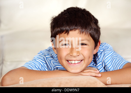 Smiling young boy watching TV  Stock Photo