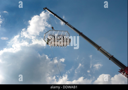 A British Airways high-flying dining table dangling from a crane 100 foot high in the sky above Brighton and Hove beach. Stock Photo