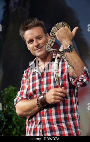 Manchester, UK, 7th September, 2013.  Nick Baker's Weird Creatures with a Ball Python regius, pet snake also known as the royal python,  a nonvenomous python species at the Manchester Pet Show, Manchester, United Kingdom,  where EventCity hosted the North West's first ever pet show. The inaugural two-day event included Feather & Scales,  pet displays, animal educational, retail outlets and an impressive theatre with an action-packed schedule featuring stars of TV’s Animal Planet. Stock Photo