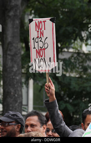 London, UK. 7 September 2013. A demonstrator with a placards in referecene to  the Battle of Cable Street, in Whitechapel, Tower Hamlets, in 1936. Credit: David Mbiyu/ Alamy Live News Stock Photo