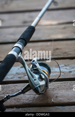close up of fishing rod reel on a dock Stock Photo
