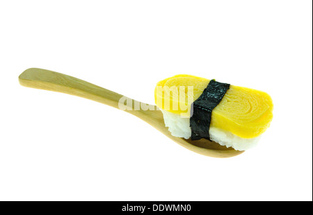 Tamago yaki is sushi using an egg, like a sushi omelette with wooden spoon Stock Photo