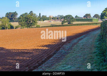 Northamptonshire 8th September 2013. Sywell. As frost lays in the shadows of a hedge. Summer comes to an end and Autumn starts to set in, the Harvest is collected leaving stubble on the ground ready for the farmers to start ploughing ready for the winter crops. Credit:  Keith J Smith./Alamy Live News Stock Photo