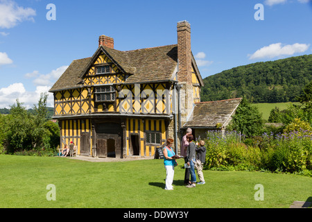 Visitors outside the timber framed gatehouse at Stokesay Castle in Shropshire.