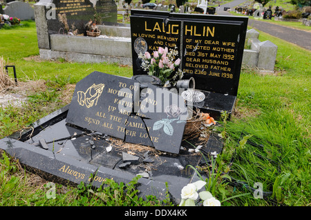 Broken gravestone in a cemetery after it has been vandalised Stock Photo