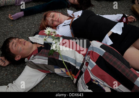 London, UK. 8th Sep, 2013.  Anti arms protestors hold a 'die in' outside one of the entrances to the Excel center where  the Defence Security and Equipment International exhibition (DSEI) is being held. Credit:  nelson pereira/Alamy Live News Stock Photo