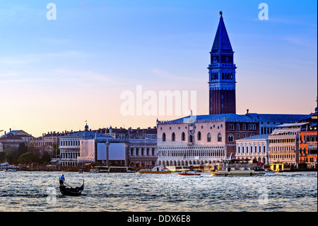 Europe, Italy, Veneto, Venice. Gondola on the Grand Canal facing the Doge's Palace, at sunset. Stock Photo