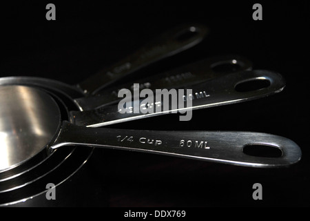 https://l450v.alamy.com/450v/ddx769/a-set-of-kitchen-measuring-cupsspoons-photographed-against-a-black-ddx769.jpg