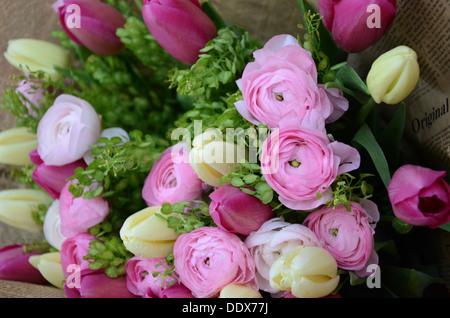 Spring pink and white flowers with lush green in a bouquet Stock Photo